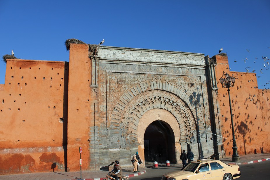 The Medina of Marrakesh is surround by a city wall that stretches 12 miles around the old Medina, and was built in the 1100s. The wall stands about 20 feet high and there are 20 gates and 200 towers along the wall. The interesting thing here with this picture are the 3 stork nests on top of the walls.