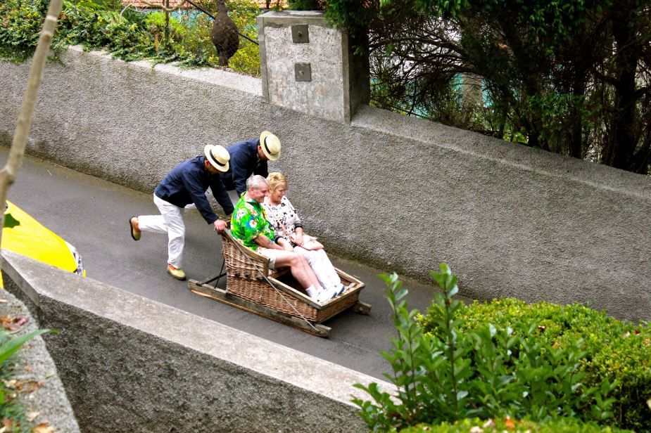 There are a few ways down the mountain with its curvy streets....one way is with a basket sleigh. Passengers sit in the basket that is on wooden rails, as two drivers push the basket down hill using their bodies to steer and their feet as brakes. The mountainside is about a 10% grade.