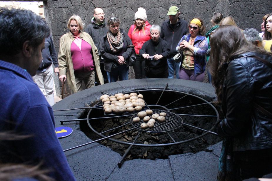 To demonstrate the constant heat, a larger pit was dug with grating placed over it. On the grating are potatoes being roasted. This is to demonstrate how the locals still today have outdoor barbeque pits used for cooking