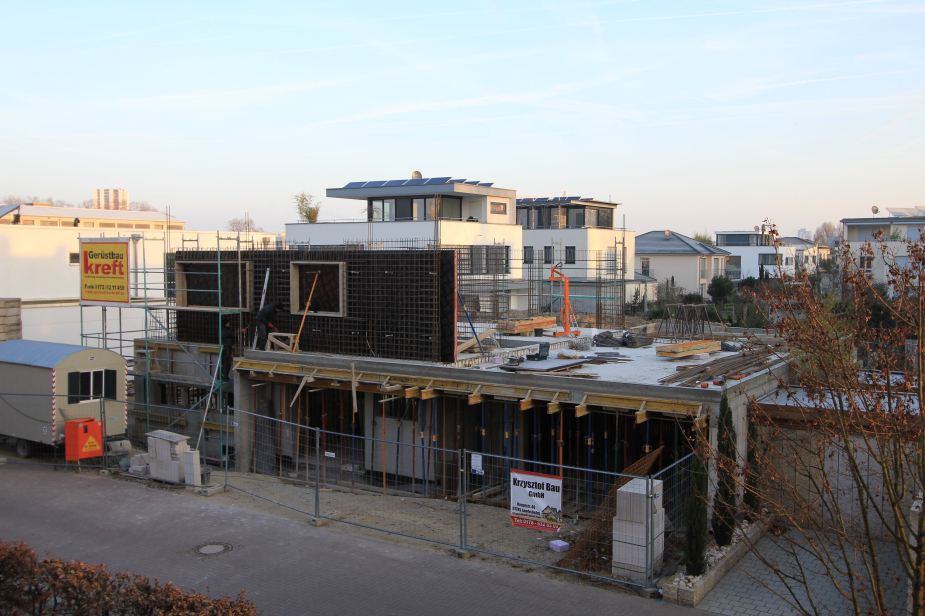 Example of a German home under construction. This is the view from our bedroom at our neighbor's house being built. Note the metal rebar that will be fitted with the cement blocks. Also, can see examples of finished homes in the background. We have very modern, contemporary homes in our neighborhood.