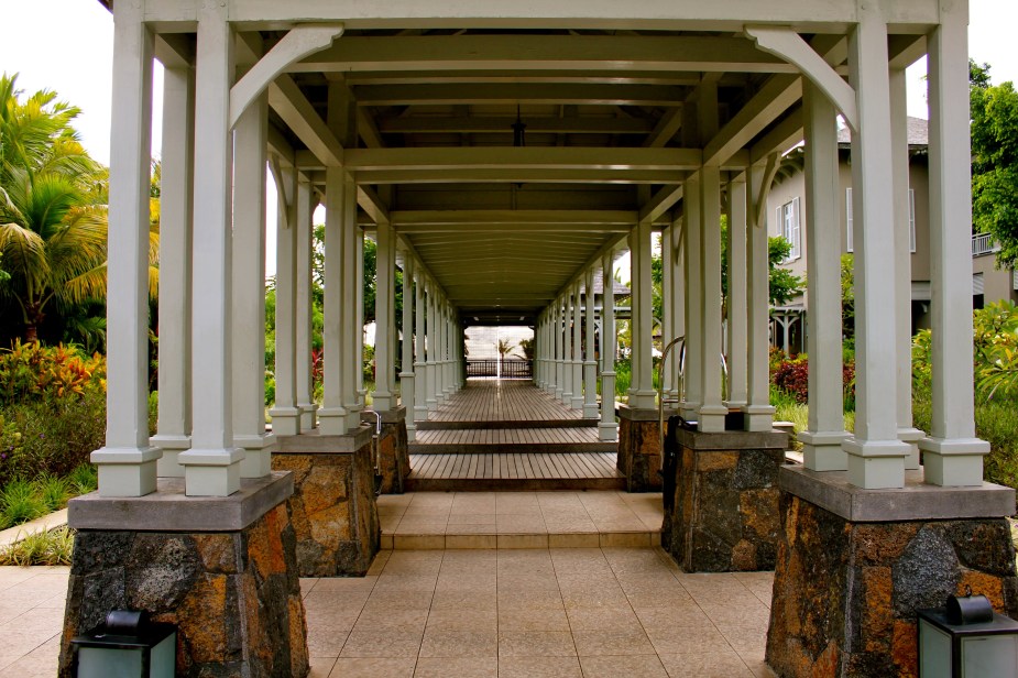 From the car drop off area, walking down the pathway with fountains on either side to the outdoor Reception area at the end