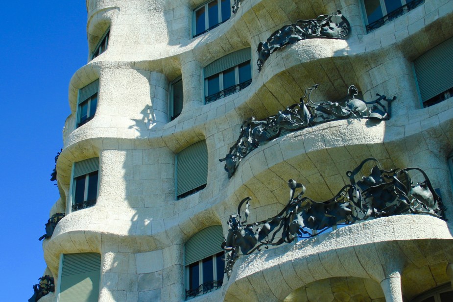 Also, Gaudi designed many buildings in Barcelona. This particular building is made to represent the love that Gaudi had for the theater. The balconies are actually masks that would be worn, which is easier to tell when stepping back from the building.