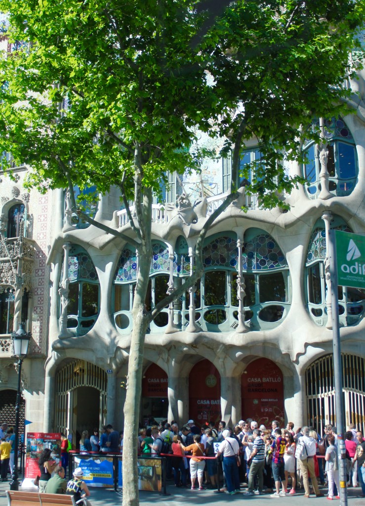 Stepping back, you can see the "masks" in the balconies. The style of Art Nouveau is characterized by curvy lines rather than straight ones, and Gaudi is considered a master at this style.