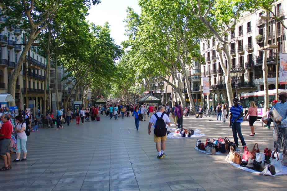 This pedestrian street was lined with vendors selling lots of souvenirs to tourists. This is the part of Barcelona where you have to be very mindful of pickpockets. Notice the guys selling real, genuine fake Prada bags on the right....the bags sit on top of a blanket, and each corner is tied to a rope. The guy stands there with the ropes in his hands, and if he sees the Police, will pull the ropes and all the bags fall into the blanket and he runs off. Admittedly, I waited to watch and see if this would happen, but alas no police.