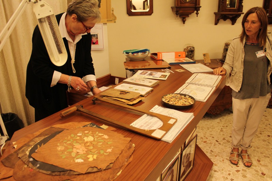 We had a demonstration of how inlaid wood art is made, which is very popular in this part of Italy. Here the artisan trims very small pieces of thin, colored wood to build the picture. Then, the pieces are assembled to form the picture being made....